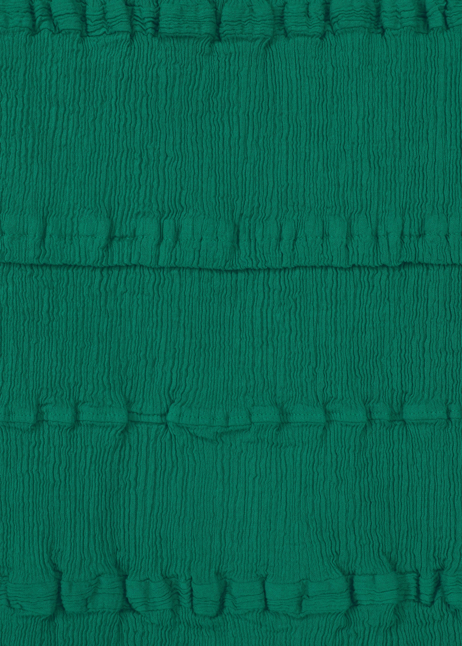 Zoomed view HaaT’s KYO CHIJIMI TSUCHIKABE features green fabric with horizontal, gathered pleats and a crepe-like texture, marked by evenly spaced ridges—ideal for apron-style tops.