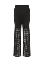 LACY UNDER by HaaT: Black stretch pants with solid ponte jersey from waist to mid-thigh, then wide-leg open-weave mesh with chemical lace embroidery down to hem. Shown on a white background.