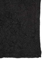 A piece of black W/P WASHER fabric by HaaT, characterized by its distinct wrinkled finish and visible creases and texture. The material evokes the appearance of a round-neck long-sleeved top in soft polyester wool jersey, covering most of the image while extending off the right and lower edges.