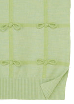 The RIBBON KNIT by HaaT features light green knit fabric with a grid pattern, tied ribbons at each intersection, and a ribbed hem with one corner slightly folded up.
