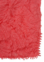 A close-up of HaaT's KUMO SHIBORI KNIT SHEER shows its textured, crinkled red fabric with a ruffled look and a decorative edge featuring small looped details.