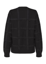 The RIBBON KNIT by HaaT is a black long-sleeved sweater featuring a grid pattern and small tied ribbons at each intersection, displayed from the back on a white background.