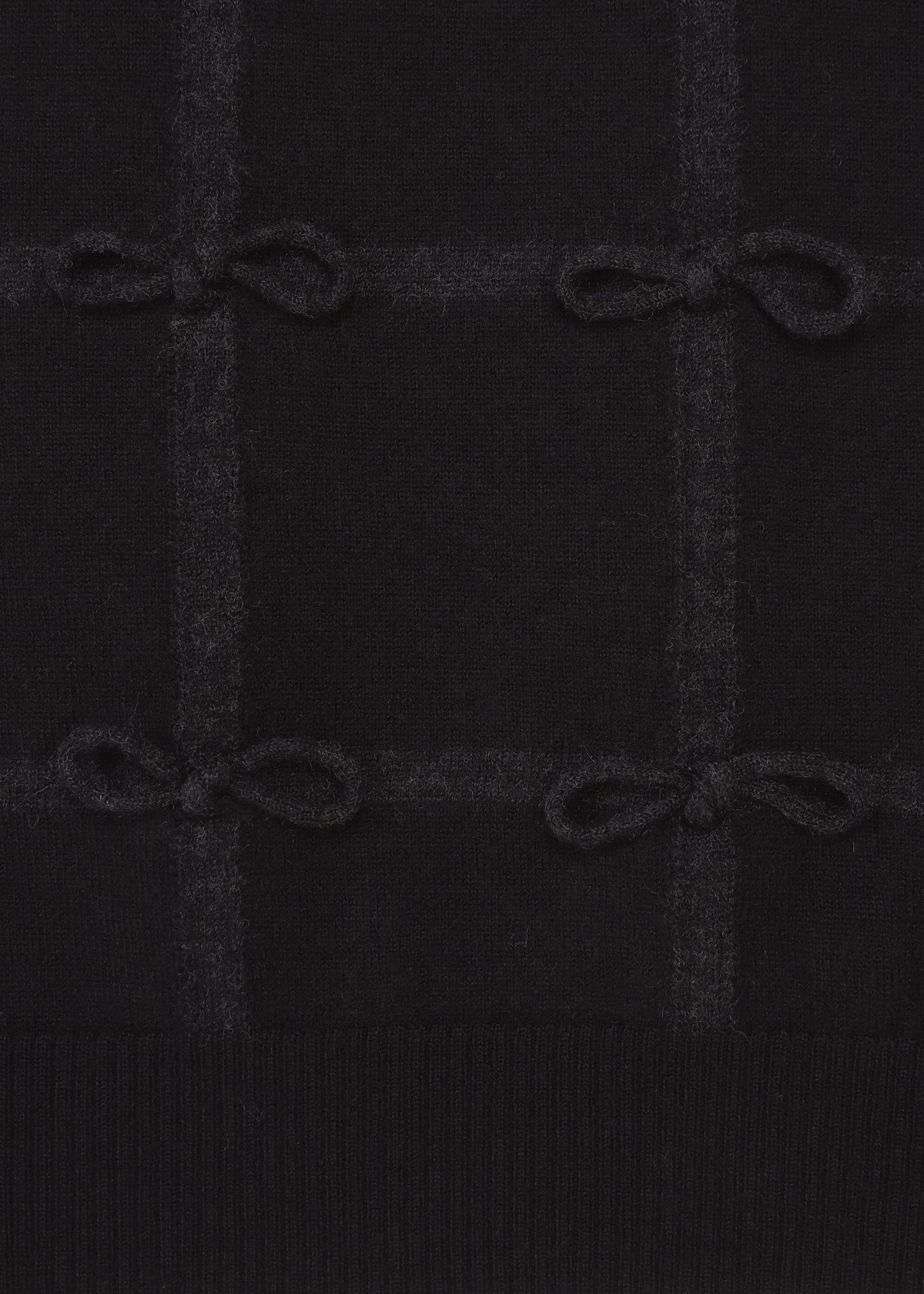 The HaaT RIBBON KNIT features black fulled wool with a subtle grid pattern, small tied ribbons at the intersections, and a ribbed bottom edge. view 4 of 7