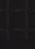 The HaaT RIBBON KNIT features black fulled wool with a subtle grid pattern, small tied ribbons at the intersections, and a ribbed bottom edge.