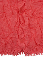 Close-up of a textured, crinkled pink KUMO SHIBORI KNIT SHEER by HaaT, featuring two matching pink buttons and a fringe detail at the bottom edge.