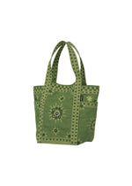 DAZZLE MIRROR BOX by HaaT—a green mini tote bag featuring patterned yellow accents, decorative stitching inspired by Bhill embroidery, and side pockets, crafted in collaboration with skilled Indian artisans and displayed on a white background.