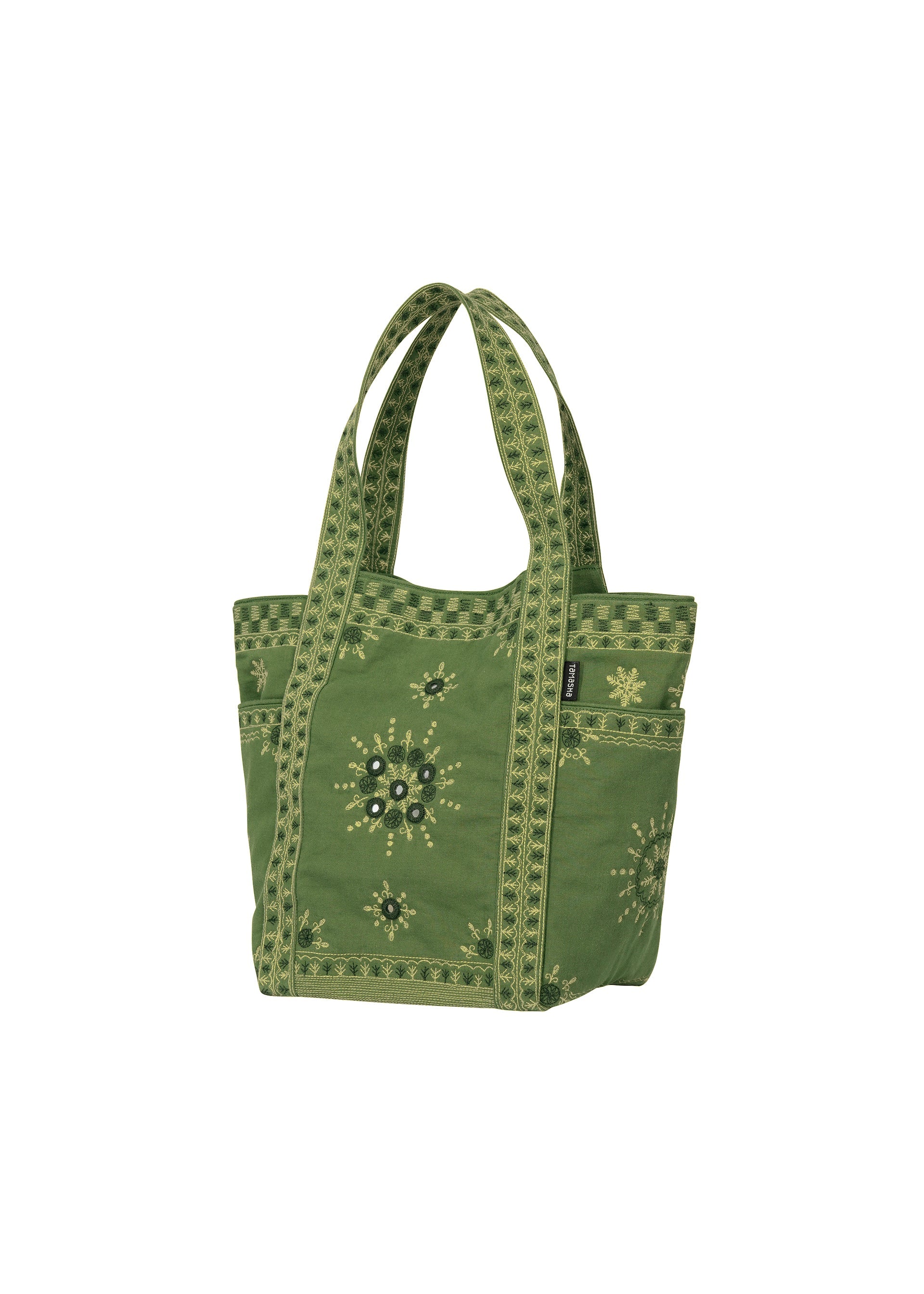 Zoomed view DAZZLE MIRROR BOX by HaaT—a green mini tote bag featuring patterned yellow accents, decorative stitching inspired by Bhill embroidery, and side pockets, crafted in collaboration with skilled Indian artisans and displayed on a white background.
