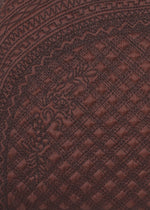 Close-up of dark brown BLOOM & PLAID BOSTON fabric by HaaT, featuring intricate Bhill embroidery with diamond motifs and ornate borders, highlighting the textured and decorative surface masterfully crafted by Indian artisans.