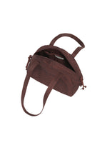 The BLOOM & PLAID BOSTON by HaaT is a small brown fabric Boston bag featuring two handles. Shown open, it reveals an inner pocket and a fabric label inside. Intricate Bhill embroidery, expertly crafted by Indian artisans, lends a touch of traditional elegance to this distinctive handbag.