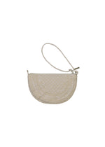 The BLOOM & PLAID BOSTON by HaaT is a beige, half-moon shaped clutch pouch adorned with intricate Bhill embroidery and features a slim wrist strap on one side. Made in India, this bag is shown against a plain white background.