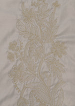 DELICATE FLORAL BHILL by HaaT features beige floral embroidery on light fabric, with intricately stitched flowers, leaves, and stems in a vertical botanical pattern.
