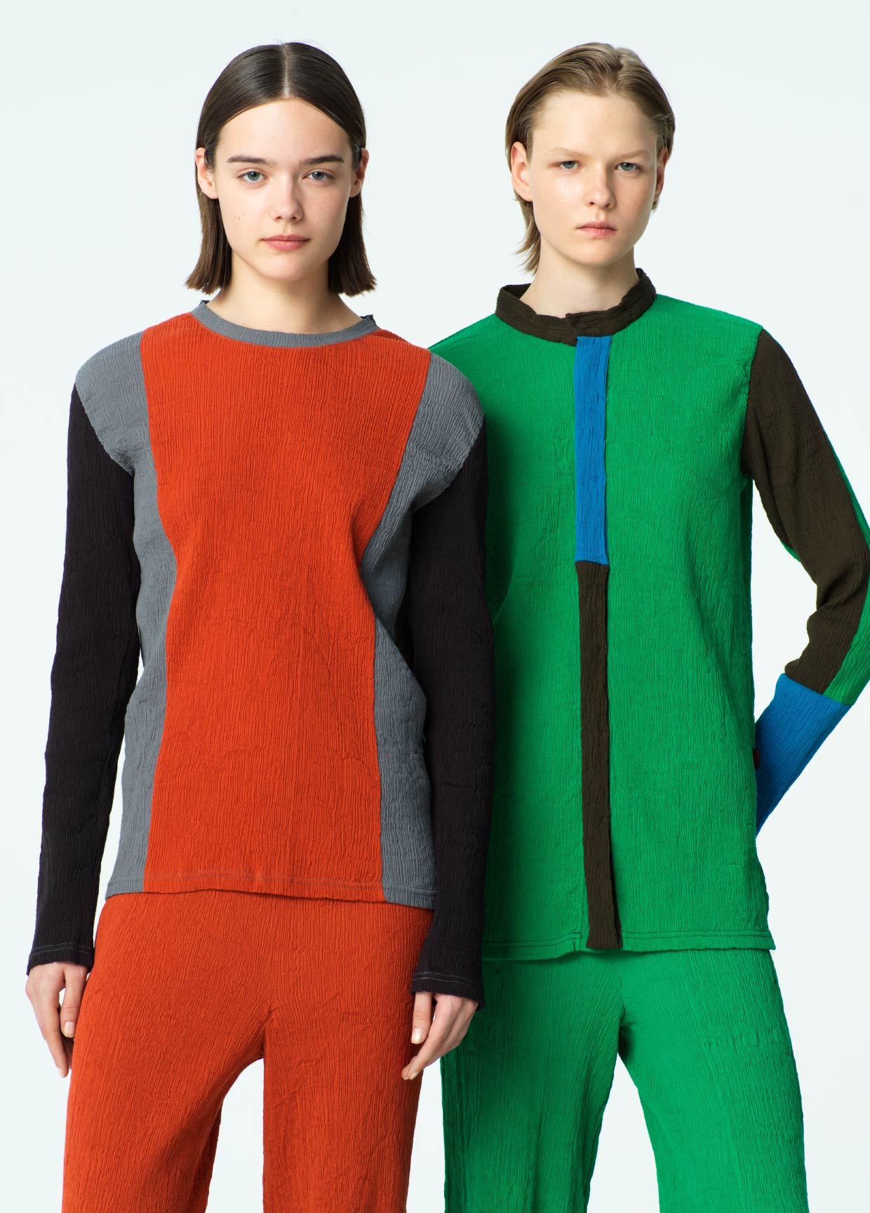 Two models wearing colorful, patchwork-style outfits on a white background
