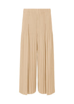 The MONTHLY COLORS : DECEMBER wide pants by HOMME PLISSÉ ISSEY MIYAKE, inspired by Japanese hakama, feature beige pleats, a wide-leg silhouette, and elastic waistband, shown against a white background. - AMMONITE BEIGE （no.42）