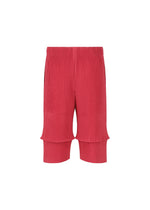 The HOMME PLISSÉ ISSEY MIYAKE PLEATS BOTTOMS 2 are bright pink, knee-length shorts with ribbed, pleated fabric and an elastic waistband, combining style and comfort. Displayed on a plain white background.