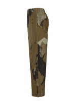 Side view of PAINTED STONE high-waisted straight pants by HOMME PLISSÉ ISSEY MIYAKE, featuring a brown, black, and beige abstract stone pattern, pleats, and a relaxed fit with an elastic drawcord waist for comfort.