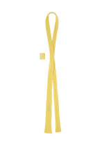 The PLEATED SEERSUCKER TIE by HOMME PLISSÉ ISSEY MIYAKE is a yellow, ribbed accessory with a matching rectangular loop. Its simple, long design resembles a necktie and adds playful brightness to any outfit, shown laid flat on a white background.