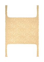 A flat-lay image of the BRANCHES & LEAVES knitted scarf by HOMME PLISSÉ ISSEY MIYAKE in beige, featuring an intricate weave and braided straps on each corner, displayed against a white background.