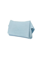 The WASHI FLAP BAG by HOMME PLISSÉ ISSEY MIYAKE is a light blue rectangular clutch with a folded flap, crafted from lightweight materials and displayed on a plain white background.