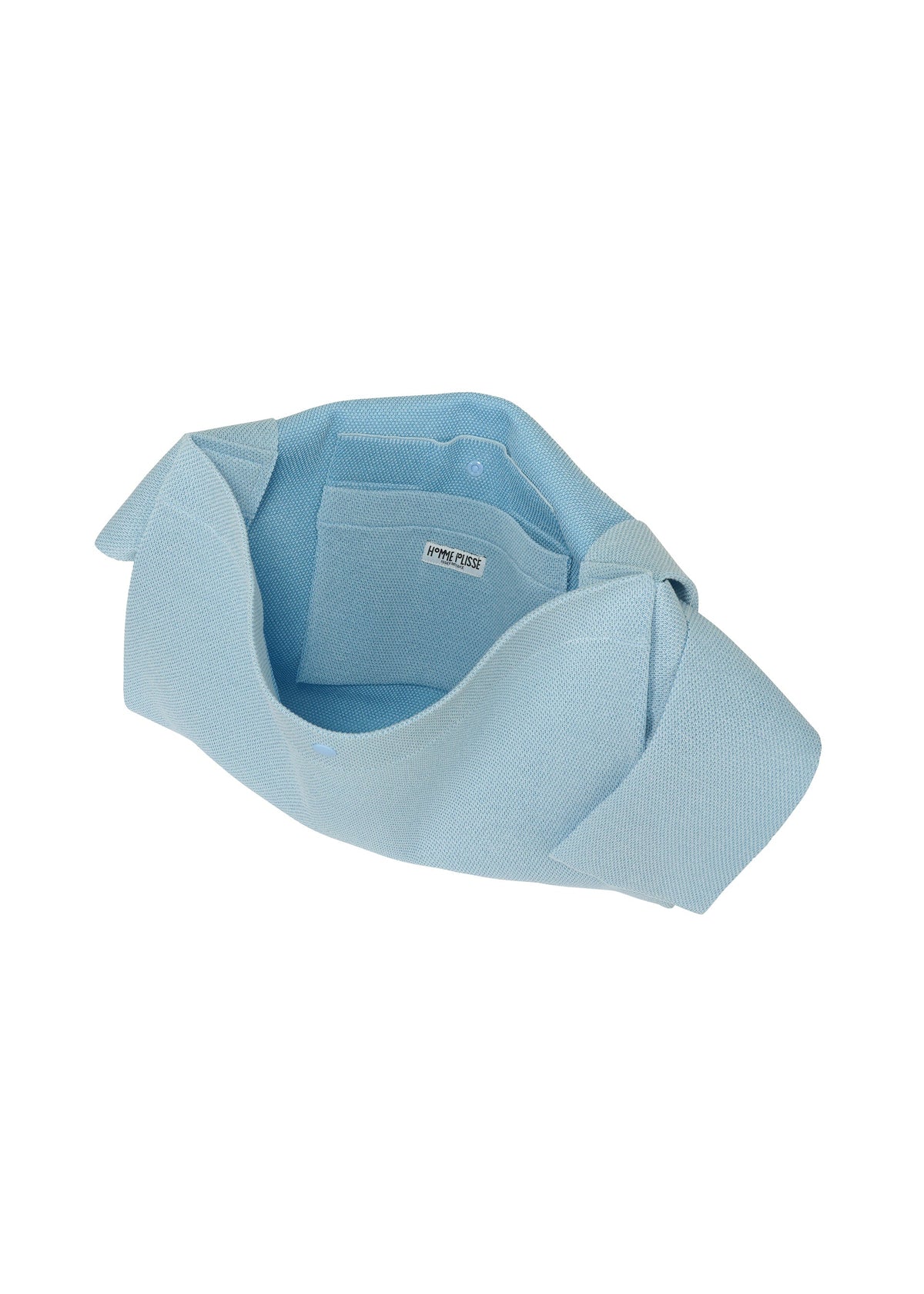 The WASHI FLAP BAG by HOMME PLISSÉ ISSEY MIYAKE is a lightweight light blue tote with a wide strap, open top, and inner pocket, shown empty against a white background. view 4 of 6