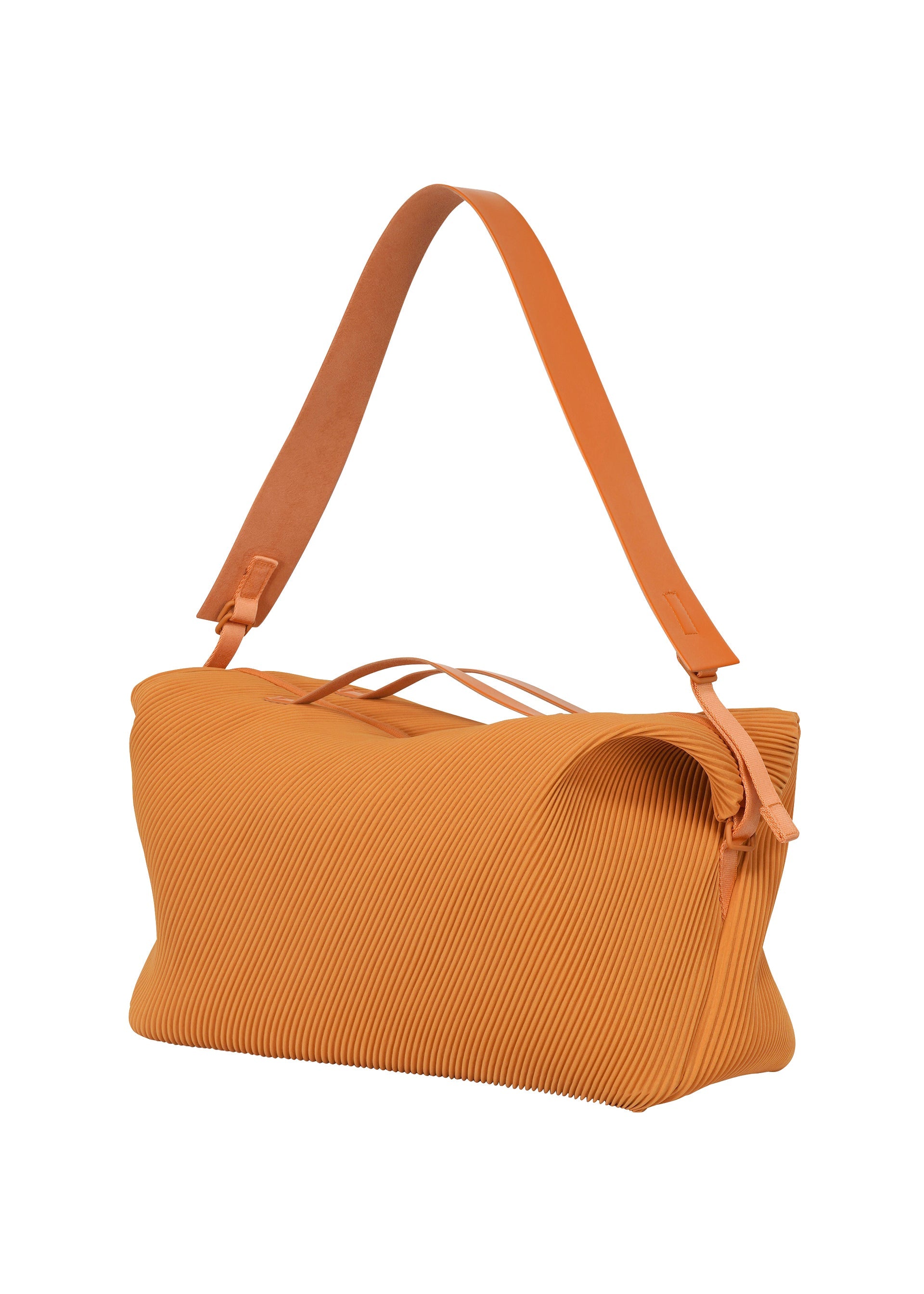 Zoomed view The PLEATS TRAVEL BAG by HOMME PLISSÉ ISSEY MIYAKE is a large, rectangular orange handbag featuring a textured pleated surface and a wide matching shoulder strap, displayed against a white background.