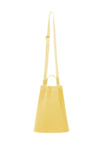 The DRAWSTRING PLEATS BAG by HOMME PLISSÉ ISSEY MIYAKE is a yellow pleated shoulder bag with adjustable strap, small handles, and light material, featuring a stylish drawcord, shown on a white background. - AGAVE YELLOW （no.54）