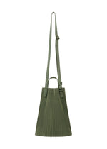The DRAWSTRING PLEATS BAG by HOMME PLISSÉ ISSEY MIYAKE is a green, lightweight shoulder bag with pleats, an adjustable strap, small top handle, and drawcord detail, shown against a white background.
