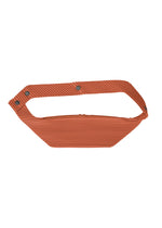 The VERSATILE CROSSBODY by HOMME PLISSÉ ISSEY MIYAKE is a rust-toned, ribbed bag with an angular handle and three metal snap buttons, styled chicly as a shoulder bag against a plain white background. - JAMBON PINK （no.23）
