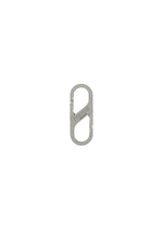 The HOMME PLISSÉ ISSEY MIYAKE CARABINER is a small, silver, metal S-shaped connector with two spring-loaded gates, resembling a double-ended carabiner and ideal as a belt loop accessory, shown against a white background. - SILVER （no.91）
