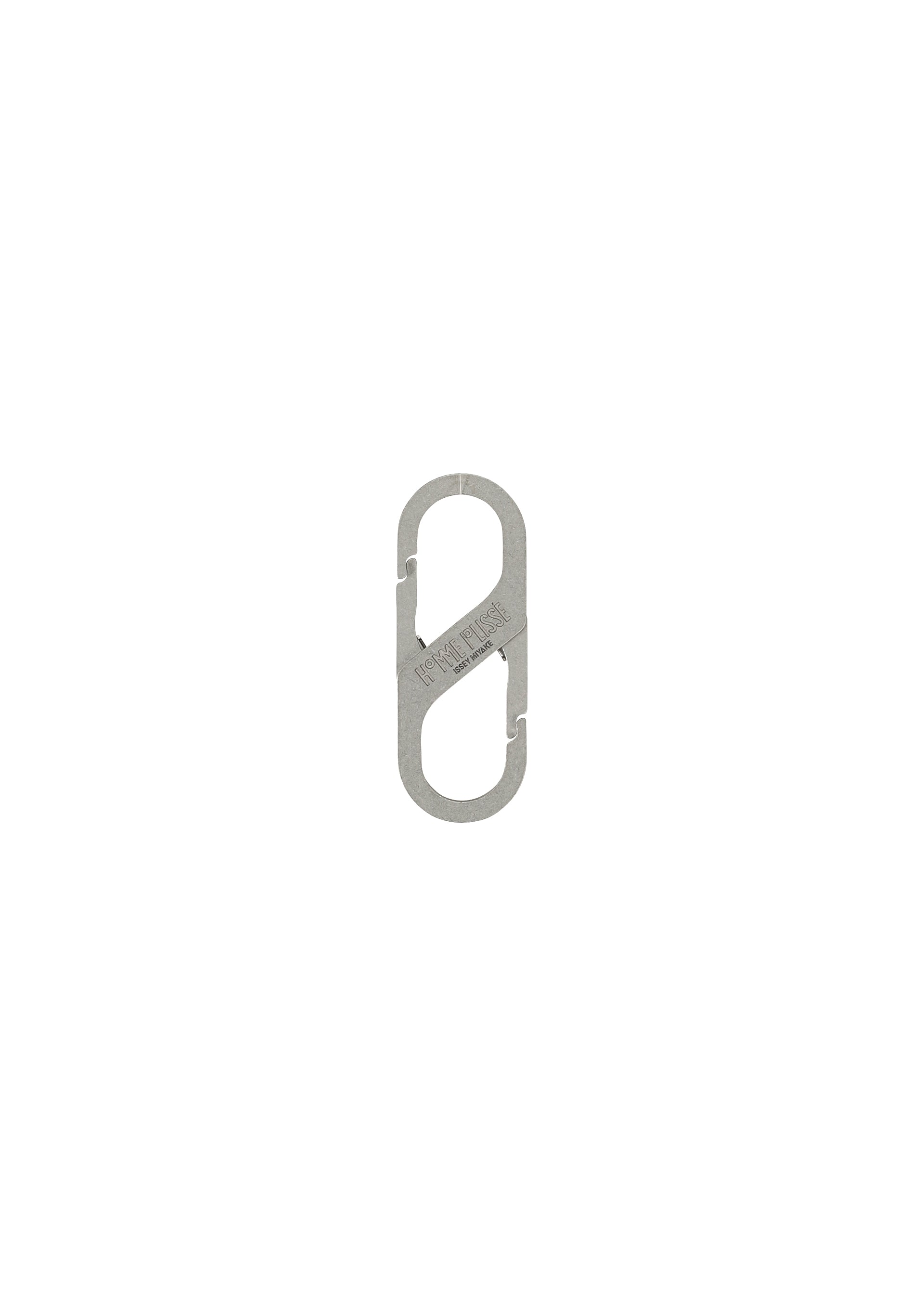 Zoomed view The HOMME PLISSÉ ISSEY MIYAKE CARABINER is a small, silver, metal S-shaped connector with two spring-loaded gates, resembling a double-ended carabiner and ideal as a belt loop accessory, shown against a white background. - SILVER （no.91）