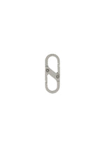The HOMME PLISSÉ ISSEY MIYAKE CARABINER is a small, silver, metal keychain clip with a double-gated oval design and two spring-loaded clasps—perfect as a belt loop accessory. Shown on a plain white background.