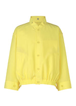 The CARRIER CARRIED jacket by HOMME PLISSÉ ISSEY MIYAKE is a bright yellow, packable, water-repellent polyester jacket with a collar, front pockets, long sleeves, and elastic waistband and cuffs, shown against a plain white background.