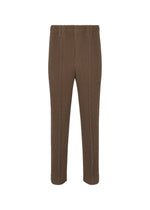 The HOMME PLISSÉ ISSEY MIYAKE TUXEDO PLEATS are brown straight-leg formal pants with subtle vertical pinstripes, an elastic waistband, and no visible pockets, shown on a plain white background. - BROWN （no.44）