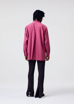 A person with dark braided hair stands facing away, wearing the HOMME PLISSÉ ISSEY MIYAKE PL RAMIE SHIRT in magenta and dark, pinstriped pants with back slits, set against a plain light background.