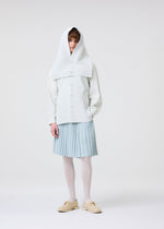 A person stands against a plain white background wearing the TAILORED PLEATS 3 light blue skirt from HOMME PLISSÉ ISSEY MIYAKE, styled with white tights, cream shoes, a white shirt, and a textured quick-drying hooded vest for a layered look.