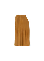 Side view of the MONTHLY COLORS : JUNE pleated skirt by HOMME PLISSÉ ISSEY MIYAKE in mustard yellow polyester with an elastic waistband, shown against a white background.
