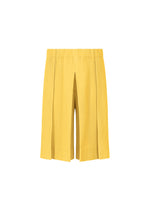 The TAILORED PLEATS 2 shorts by HOMME PLISSÉ ISSEY MIYAKE are yellow hakama-style pleated shorts with an elastic waistband, crafted from quick-drying polyester and shown on a plain white background. - AGAVE YELLOW （no.54）