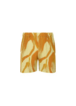 FRUITS & VEGETABLES shorts by HOMME PLISSÉ ISSEY MIYAKE feature a yellow and orange abstract wavy pattern with subtle Italian market prints, presented on a white background. - YELLOW （no.52）