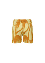 HOMME PLISSÉ ISSEY MIYAKE's FRUITS & VEGETABLES high-waisted ribbed shorts, featuring an abstract orange and beige swirl inspired by Italian markets, are shown against a plain white background.