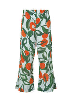 The HOMME PLISSÉ ISSEY MIYAKE FRUITS & VEGETABLES pants feature a vibrant nature-inspired print with bold orange fruit and green leaves on white, evoking Italian market style for a relaxed, summery vibe. - BLUE (no.72)