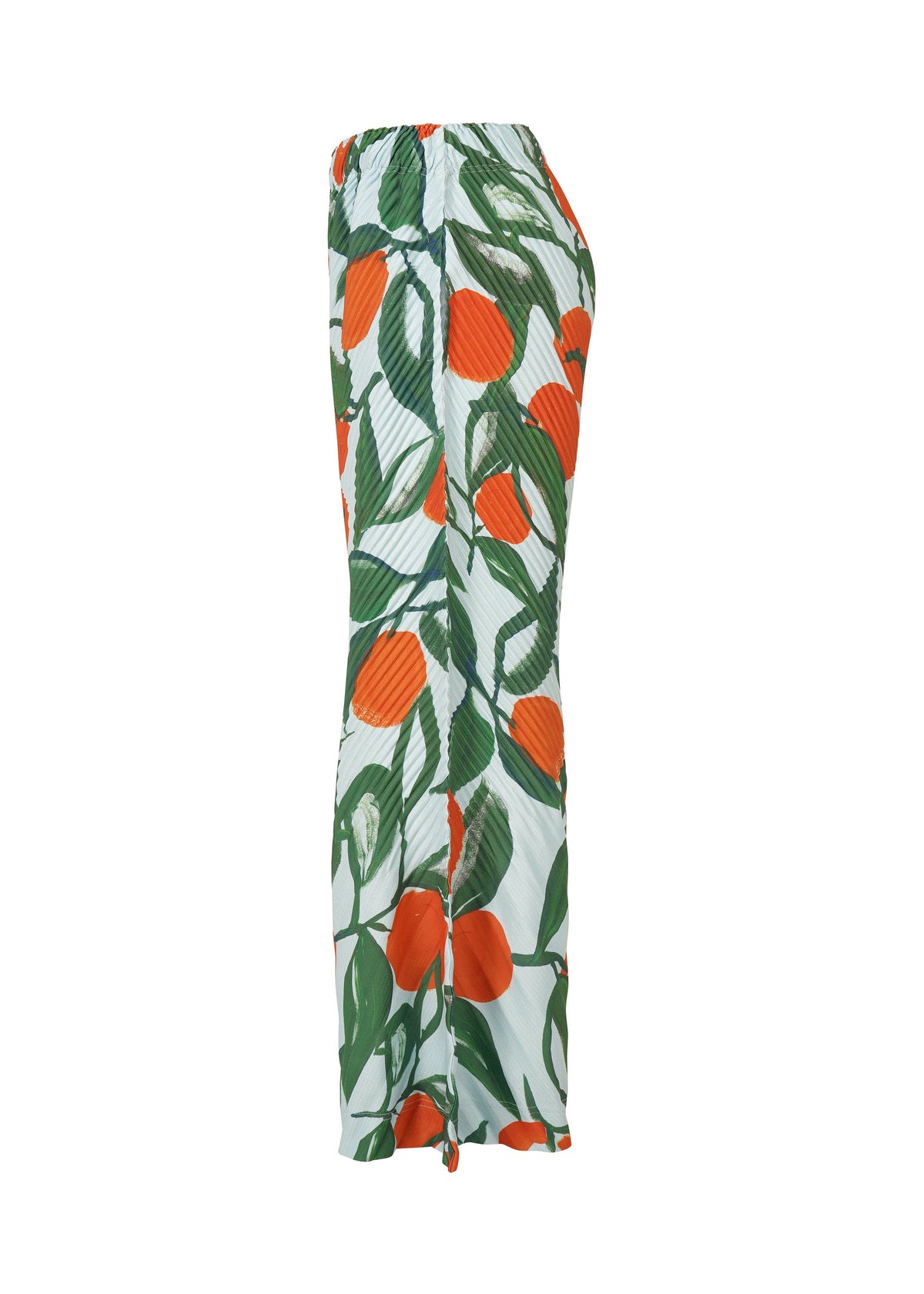 Side view of the FRUITS & VEGETABLES skirt by HOMME PLISSÉ ISSEY MIYAKE, with an elastic waistband and bold Italian market-inspired prints of large orange fruits and green leaves on a white background. view 4 of 6