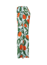 Side view of the FRUITS & VEGETABLES skirt by HOMME PLISSÉ ISSEY MIYAKE, with an elastic waistband and bold Italian market-inspired prints of large orange fruits and green leaves on a white background.