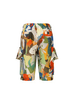 PALETTE MARBLED shorts by HOMME PLISSÉ ISSEY MIYAKE feature a vibrant handcrafted marble print in green, blue, orange, yellow, and brown on white. Each elastic-waist pair has side pockets and a unique pattern.