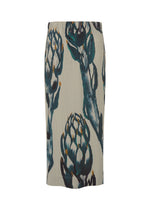 The FRUITS & VEGETABLES skirt by HOMME PLISSÉ ISSEY MIYAKE is a knee-length cream piece with vertical ribbing, featuring a bold artichoke print in green, blue, and gray.