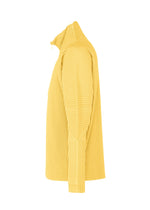 The MONTHLY COLORS : MARCH pullover by HOMME PLISSÉ ISSEY MIYAKE is a yellow, long-sleeve, high-neck ribbed half-zip sweater in quick-drying polyester with vertical textured lines, shown side view on a white background.