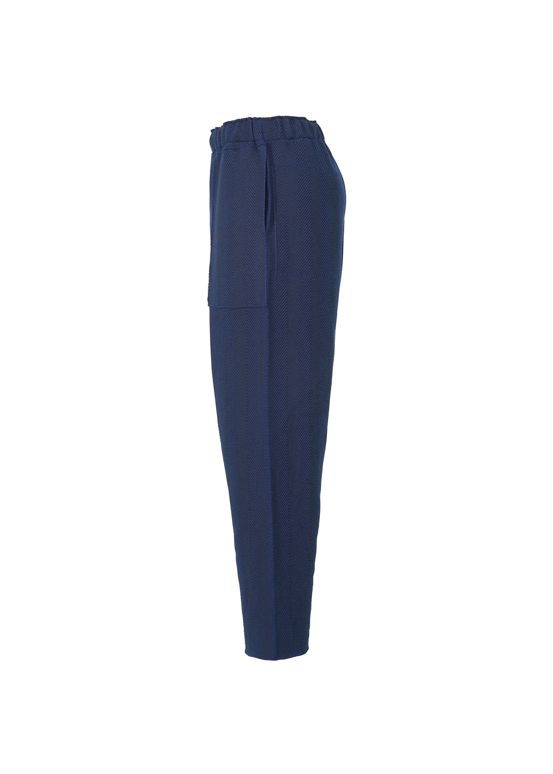 Zoomed view Side view of HOMME PLISSÉ ISSEY MIYAKE INLAID KNIT pants in navy blue, featuring an elastic waistband and large side pocket, with a lightweight, structured knit design, displayed on a plain white background.