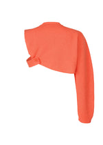 The WAFER KNIT top by HOMME PLISSÉ ISSEY MIYAKE is a bright orange, asymmetrical knit with a waffle texture, one long sleeve, and a single shoulder strap accented by a button—ideal for layering and shown on a white background.