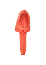 The HOMME PLISSÉ ISSEY MIYAKE WAFER KNIT sweater in coral is neatly folded with crossed sleeves and the collar facing up, displayed on a plain white background.