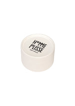 A round white container with a lid displaying HOMME PLISSÉ ISSEY MIYAKE in black, inspired by the modern style of the IN THE SHADOW PLEATS TIE, set against a plain white background.