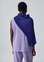 A person stands facing away, wearing a sleeveless, light purple pleated top and matching pants, styled with the RUSTIC MESH STOLE in dark blue from HOMME PLISSÉ ISSEY MIYAKE draped over one shoulder against a plain light background.