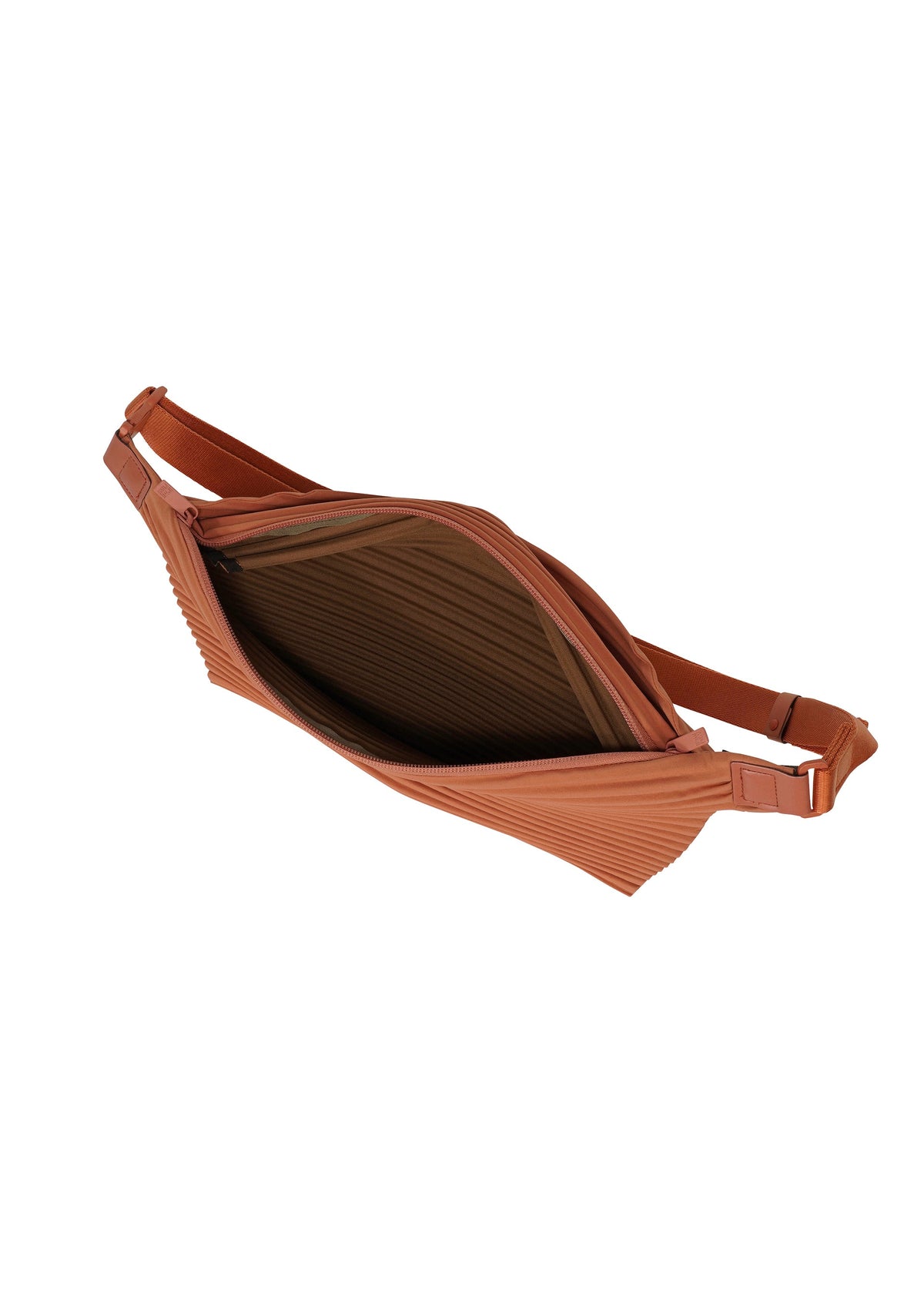 Showcasing its spacious, ribbed interior and secure zipper closure, the PLEATS SLIM BAG from HOMME PLISSÉ ISSEY MIYAKE is a rust-colored crossbody bag with an adjustable strap. Lightweight and versatile, it also works perfectly as a shoulder bag for multiple carrying options. view 4 of 6